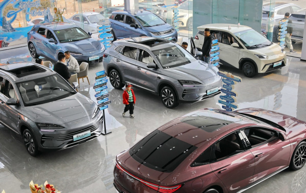 Consumers select new energy vehicles in a BYD 4S store on March 11 in Qinhuangdao, Hebei province