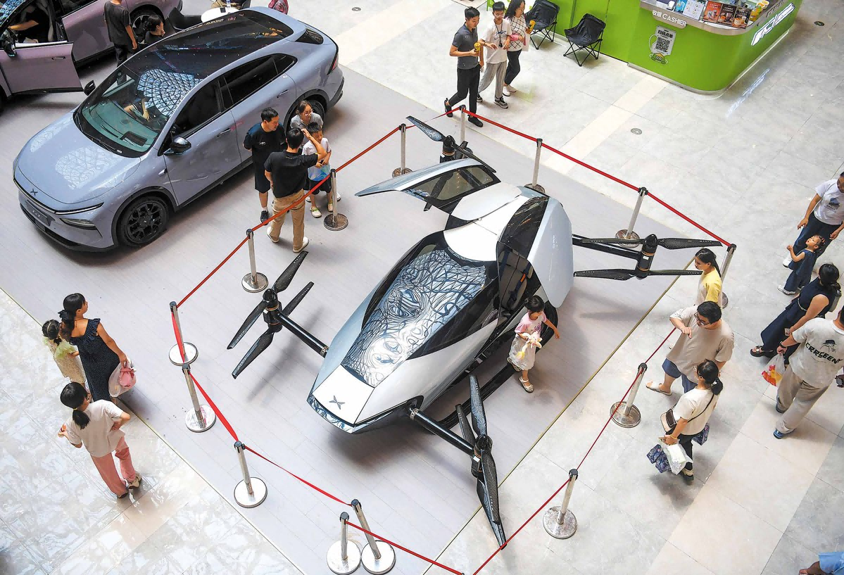 Visitors check out Xpeng vehicles on display at a shopping mall in Luoyang
