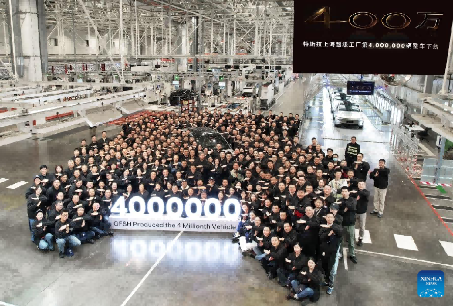 Staff members pose for a group photo to mark the 4 millionth vehicle produced here at Tesla's Gigafactory in Shanghai Staff members pose for a group photo to mark the 4 millionth vehicle produced here at Tesla's Gigafactory in Shanghai